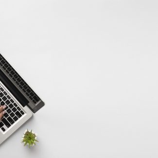 top-view-person-writing-laptop-with-copy-space